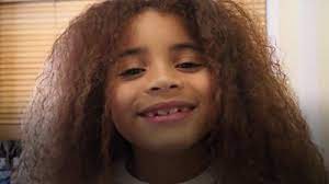 Sometimes a quiff or large curl emerges from under a boy's cap. Farouk James The Boy With Very Long Hair Bbc News