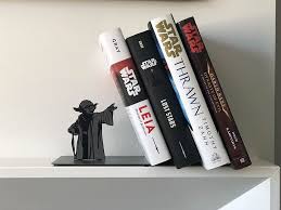 A Metal Jedi Master Yoda Bookend That Appears To Use The Force To Hold Up Books Star Wars Bedroom Star Wars Decor Star Wars Room