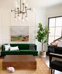 The mismatched collection of porch furniture looks cohesive thanks to white paint, which coordinates with the porch's white framing and the house's white trim. How To Decorate With Green