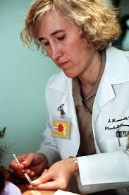 LT. CMDR. (Dr.) Susan Kaweski gives a patient an injection as part of his  post-operative
