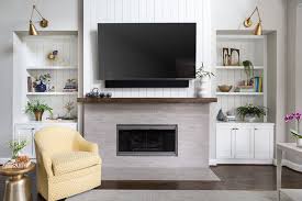 The front of the room has a big flat screen tv and a cheerful fireplace. How To Decorate A Mantel When You Have A Tv Above It Designed