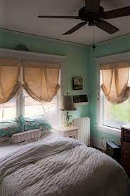 In this layout, two beds rest opposite one another with a desk between both of them. Tiny Bedroom Is Delightful Because It Has Windows On Two Sides Tiny Bedroom Home Inspiring Spaces