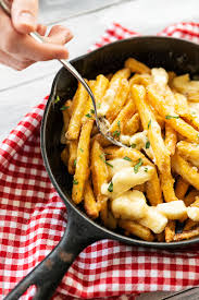 1 part chicken bouillon (preferably powder) to 1 part beef or veal bouillon. Canadian Poutine In Cast Iron Pan By Sean Locke Poutine French Fries Stocksy United