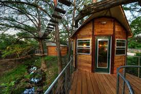 Gliding across steel ziplines from platform to platform high in the treetops. Cypress Valley Treehouse Lodging
