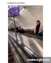 An escalator can never break, it can only become hilarious. Guy Uses Smile Filter On People On The Other Side Of Escalator Meme On Make A Gif
