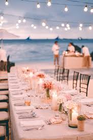 Long Set Table With Cutlery And Plates Glasses And Candles Small Flower Bouquets In White Beach Wedding Tables Boho Beach Wedding Beach Wedding Centerpieces