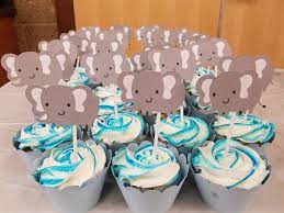 To make sure it becomes an adorable focal point of the party consider bringing in the wild theme by placing the cake on a rustic wood board. Shower Baby Elephant Themed Baby Shower Cupcakes