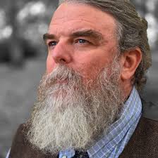 Who is the person in the photo with Stanley Hicks from around 1980?