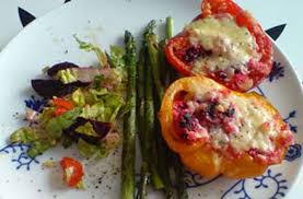 Using parsley, lemon zest and garlic to make a gremolata herb mix for flavoring the couscous stuffing with and mixed with raisins and chopped tomato salad served inside large red roasted peppers, in the oven. Stuffed Peppers With Couscous Courgette And Mozzarella Italian Recipes Goodtoknow
