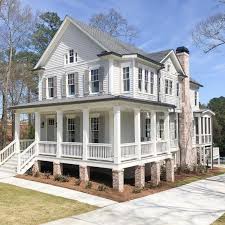 The 3 car garage features white garage doors which matches the white trim elsewhere on this home's exterior. White House Exterior Paint Colors Inspiring Images To Help Now Hello Lovely
