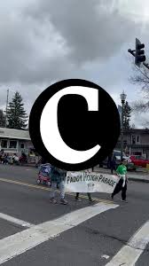 Addison Cochran, 12, and Jim Fenske search for trash along the shores of  the Columbia River during a Martin Luther King Jr. Day beach cleanup event 