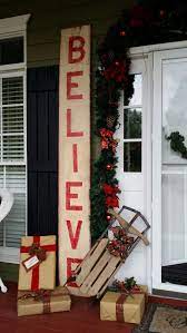 This charming entry features garland, holiday houses, hanging lanterns, a wreath, a christmas tree, pillows, and a throw for inviting comfort. 50 Best Christmas Porch Decoration Ideas For 2021