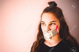 A Young Girl With European Appearance, Her Mouth Taped With Small Cash.  Green Eyes, A Look To The Side. Home Secrets, Skeletons In The Closet. Copy  Space, Toning. Stock Photo, Picture and