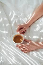 Partial View Of Woman With Cup Of Coffee In Bed In Morning Stock Photo Dissolve