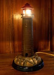 An Early 1900 S Cast Brass Lighthouse Mounted On A Black Bakelite Base Lighthouse Cast Brass Vintage An Homemade Lamp Shades Lighthouse Lamp Nautical Lamps