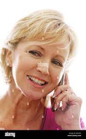 Older Mature Middle Aged Woman Using A Retro Mobile Cell Phone Isolated  Against A White Background From Her Home Or Business Office Stock Photo -  Alamy