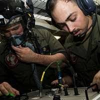 SENIOR airman Bruce Rogers (left), load crew member and STAFF SGT. Keith  Miller (right), load crew chief, both from the 494th Fighter Squadron, 48th  Fighter Wing, RAF Lakenheath, England, upload ammunition into