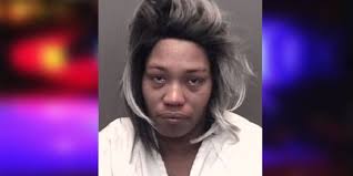 Woman accused of ramming car, pushing it across the street