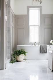 Gray Wood Paneling Accents A Wall Wall And Partially Frames A Window Positioned Above An Oval Freest Wood Bathroom Bathroom Interior Design Bathroom Wall Decor