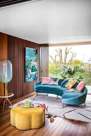 Guy in yellow sweater reads interesting book blue ottoman and sits thought watches. What Is Maximalist Decor Style And 33 Gorgeous Ideas Digsdigs
