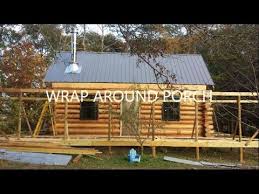 Warm up next to the fireplace in the great room. Wrap Around Porch Building A Log Cabin Youtube