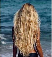 A blonde surfer girl underwater doing duck dive holding surfing board left behind air bubbles in blue water background under. Beach Hair In 2021 Surfer Hair Surfer Girl Hair Beach Hair