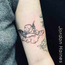 The sweet cherub tattoo, this is a classic one. Fine Line Cherub Done At Paper Moon Tattoo Company Cupid Tattoo Baby Tattoos Tattoos
