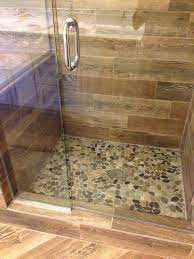 What are some of the most reviewed products in tile? Shower Remodel Natural Look With Mosaic Flat Rock Pebbles And Wood Looking Tile Modern Badezimmer Boston Von Little Dragon Decor Houzz