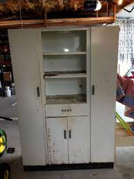 Giving your metal kitchen cabinets a makeover typically involves painting them, but you can also sand heavily scratched metal to make it smooth and shiny again. Metal Cabinet Makeover Roadside Rescue Metal Storage Cabinets Vintage Metal Cabinet Metal Cabinet