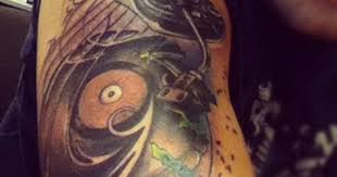 This design has a guitar going through a skull's head. Image Result For Record Player Tattoo