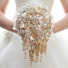 These ornaments add opulence and sheen to any bridal outfit. Gold Brooch Bouquet Wedding Bouquet Bridal Bouquet Bridesmaids Bouquet Wedding Decor Brooch Decor Wedding Brooch Bouquets Gold Bouquet Wedding Bridal Jewellery