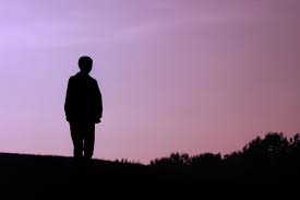 Boy standing under tree at sunset. Alone Mgh Clay Center For Young Healthy Minds