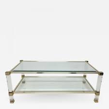 Whether you have a small or large living room space, a glass coffee table or glass top coffee table provides a more contemporary look, thereby elevating the style of the entire area. Pierre Vandel Signed Pierre Vandel Lucite Gilded Metal Glass Coffee Table