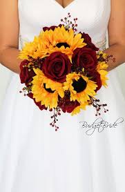 Sunflowers And Dark Red Roses Accented With Red Berries Perfect Wedding Flower Bouqu Sunflower Wedding Bouquet Sunflower Themed Wedding Flower Bouquet Wedding