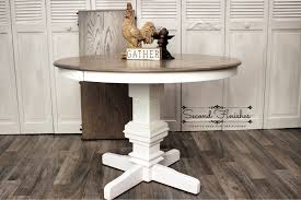 The dining table's textured white pedestal base feels rich and substantial, while the inlay tabletop with plank effect is beautified with a light grayish brown finish for a relaxed sensibility. Restyled White Pedestal Table Second Finishes