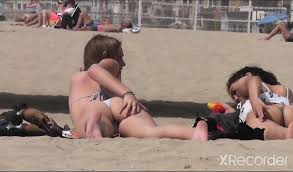 Teens at the beach touching their ass cheeck