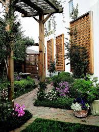 Obelisk trellis in the backyard 30 Best Trellis Ideas For 2021