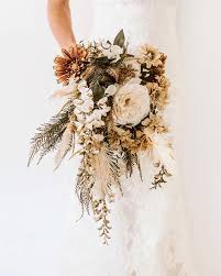 Wedding bouquet on a wicker chair. Sun Bleached Blooms The 2019 Trend For Dried Wedding Flowers Festival Brides Cascading Wedding Bouquets Dried Flowers Wedding Dried Flower Bouquet