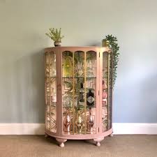 Cream cabinets with a brown antique glaze combine with espresso wood floors and dark emperador marble to great effect. Upcycled Vintage Glass Drinks Cabinet Hand Painted In Damask Pink Gold Decoupaged Art Deco Geometric Tropical Cocktail Display Cabinet Vinterior