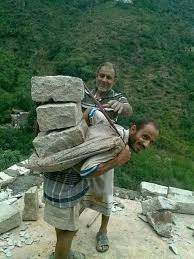 يمني يحمل أحجار على ظهره Wood Firewood Texture