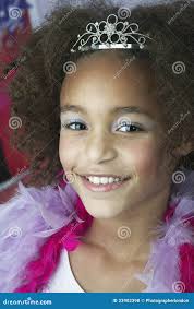 Young Girl in Makeup Tiara and Boa Stock Photo