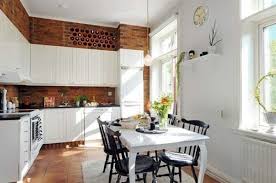 The homeowners opted to display pretty porcelain. How To Decorate Space Above Kitchen Cabinets