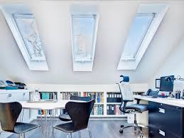 A small and elegant attic home office with a reading nook by the window, a wooden chair and a low coffee table, a desk and a mustard chair plus lots of skylights. 20 Small Attics That Will Make You Want To Move Upstairs House Home