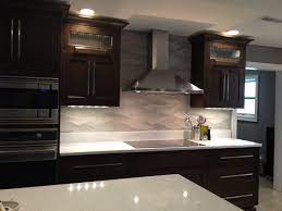 Remodeled Kitchen Wavy Porcelanosa Backsplash Ge Monogram Induction Cooktop Cambria Countertop Ww White Tile Backsplash Kitchen Backsplash White Backsplash Ceramic tile for kitchen flooring.