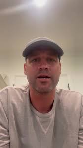 Stella Cash, Vice President of Development & Strategic Partnerships at  Sparrow Hospital receives a Big Ten Championship pendant from Coach  Merchant.