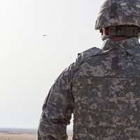 US Army (USA) Private First Class (PFC) Ray Brownlee stands a night watch  at Forward Operating Base (FOB) Hotel, as a storm rapidly approaches Najaf,  Iraq (IRQ), during Operation IRAQI FREEDOM. PFC