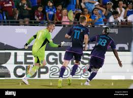 Charlotte FCs Karol Swiderski (11) and Kerwin Vargas (18) chase goalkeeper  Kristijan Kahlina (1) as he celebrates blocking the final penalty kick, by  Cruz Azul midfielder Kevin Castano, in a Leagues Cup