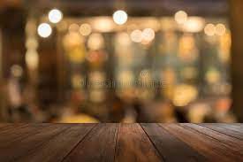 empty wooden table of brown in front warm orange color of bokeh on wooden backg ad brown front table red flower wallpaper wooden tables orange color