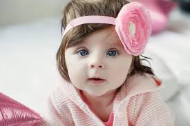 Bright Blue Eyed Beauity 6 Month Old Baby Girl Looks Closely at the Camera  Stock Image