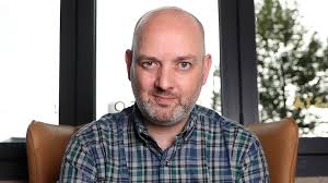 Beidh Jake Mac Siacais ina threoraí ag Caoimhe Ceol Ní Chathail ar Shlí na  Gaeltachta in Iarthar Bhéal Feirste mar chuid den fheachtas An tSiúlóid  Mhór nó The Big Walk. 19:03 ar